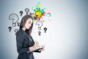 Woman thinking about what questions to ask during an interview